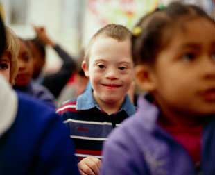 Six-year-old boy with Down syndrome with fellow pupils in a school setting